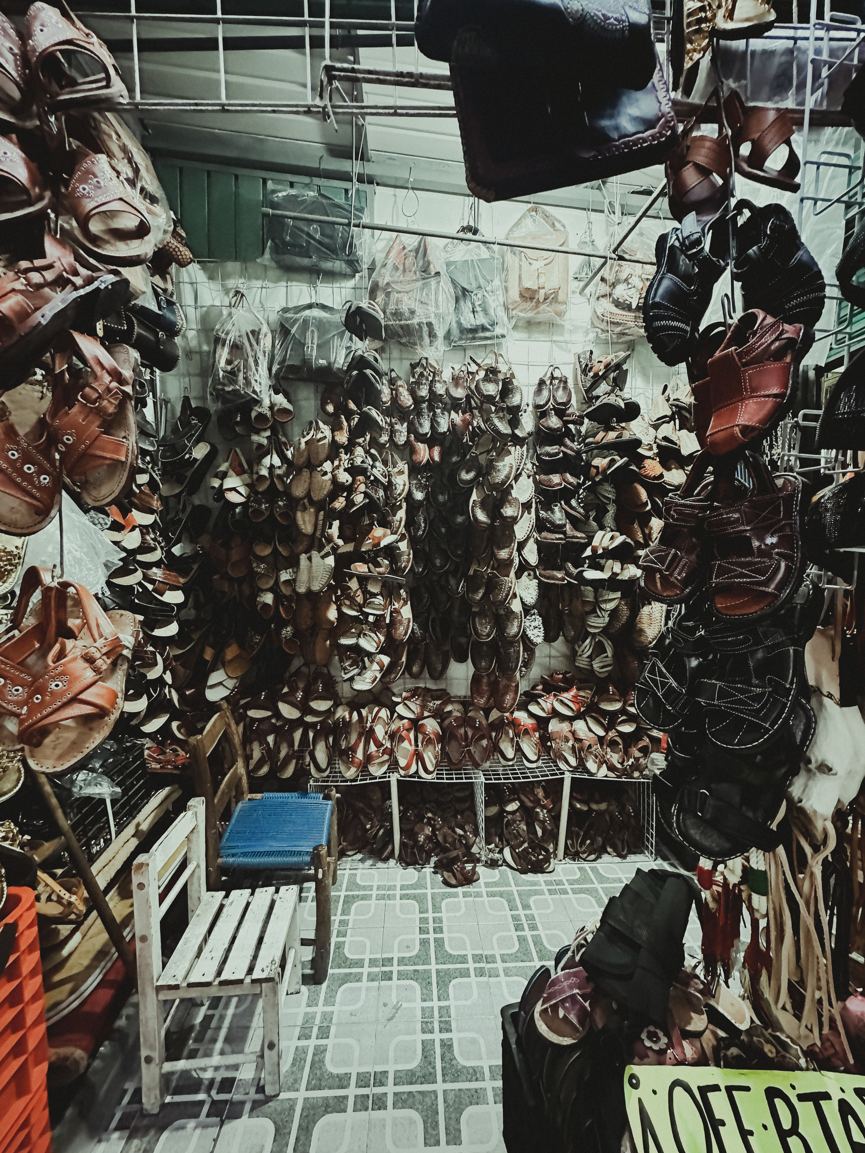 Market stall filled with hanging leather sandals